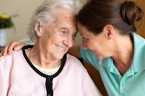 Dementia and occupational therapy home caregiver and senior adult woman