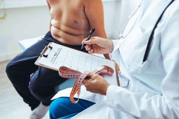 Female nutritionist gives consultation to patient indoors in the office